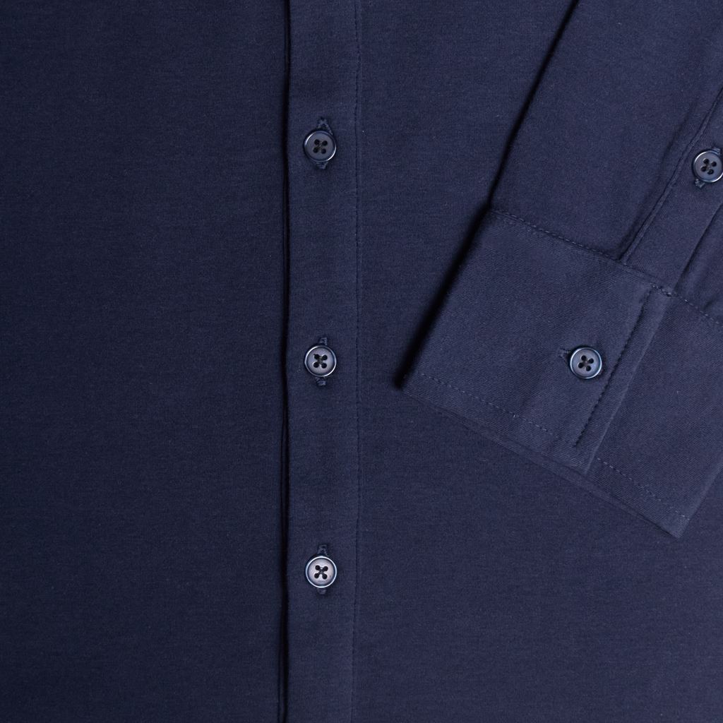 Close-up of a black shirt with button details. Color: Navy