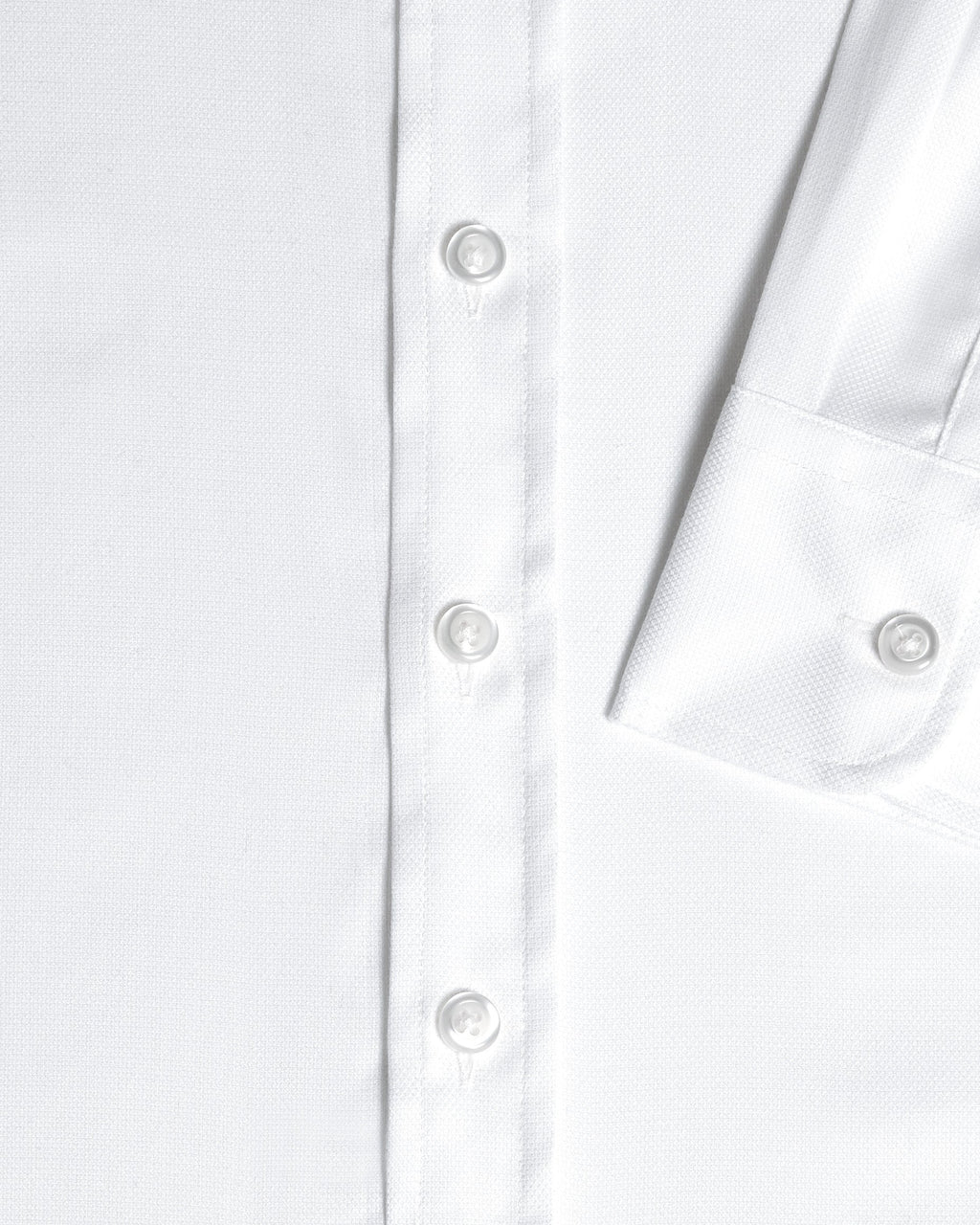 Close-up detail of a white long-sleeve button-down shirt showing the front placket with white buttons and sleeve cuff. Color: White