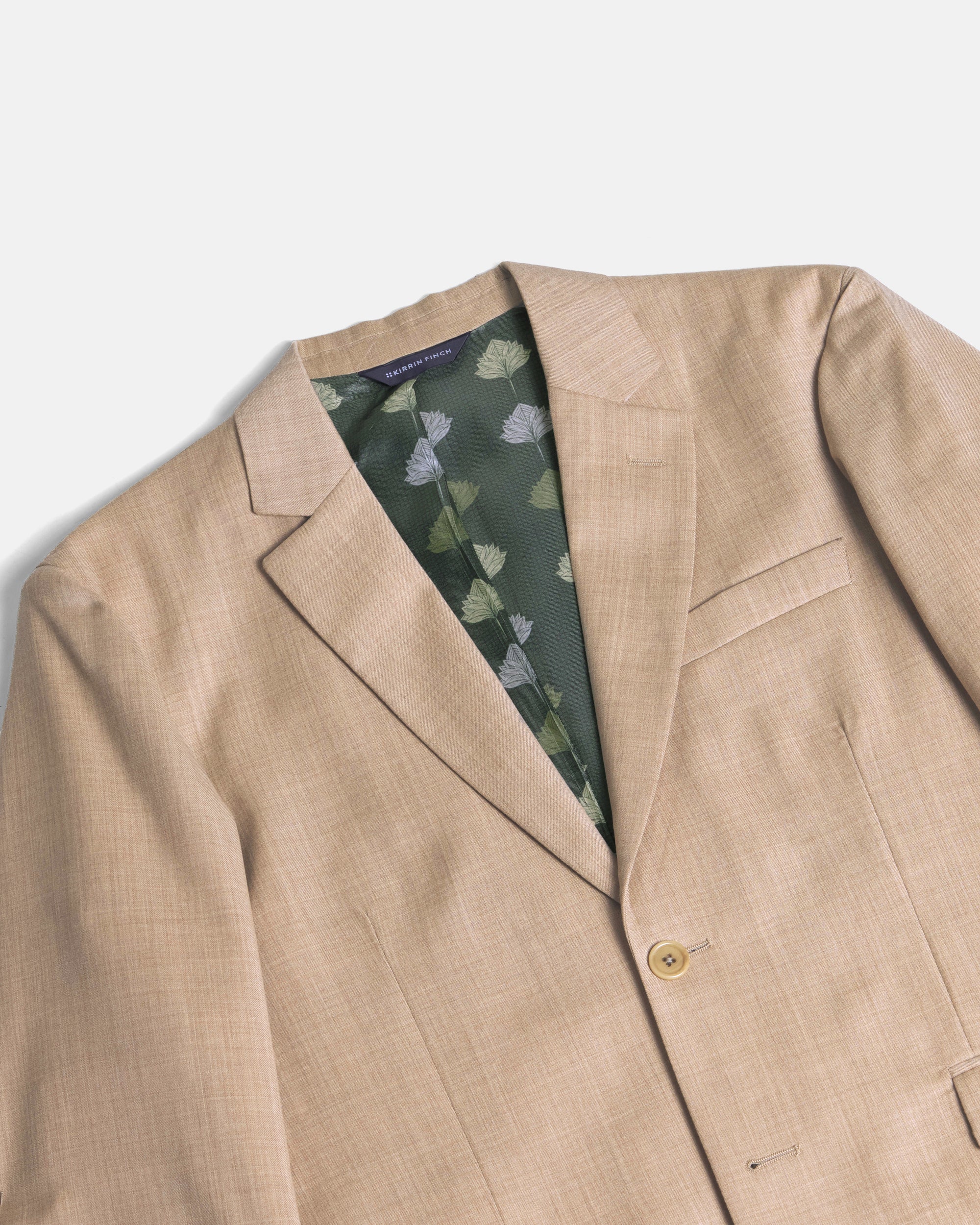 Beige blazer with a floral pattern inside on a white background. Color: Desert
