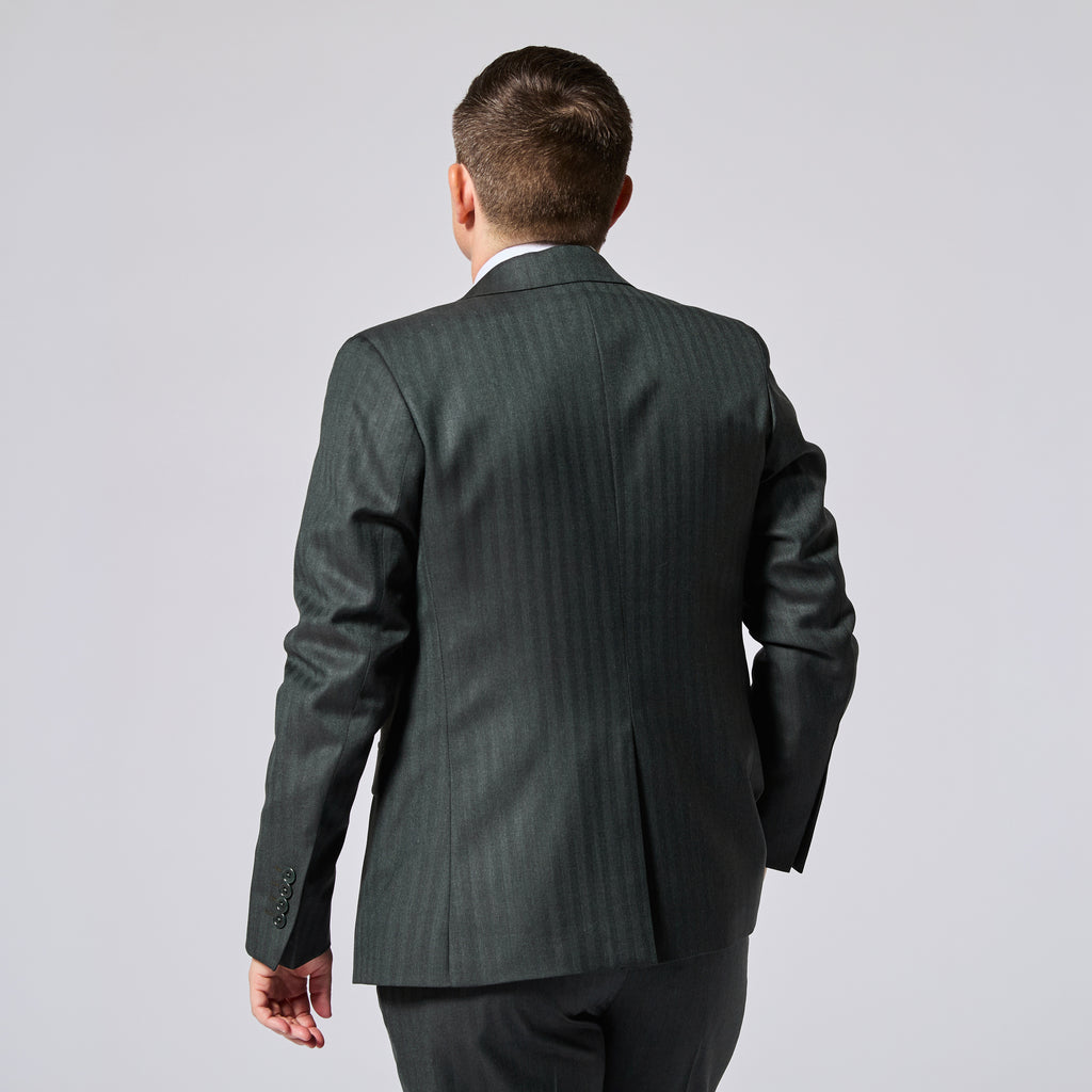 Model photographed from behind wearing a dark green blazer with matching pants. Color: Midnight Pine Herringbone