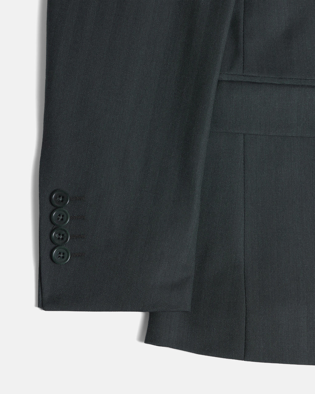 Close-up of a dark green suit jacket showing the buttoned cuff. Color: Midnight Pine Herringbone
