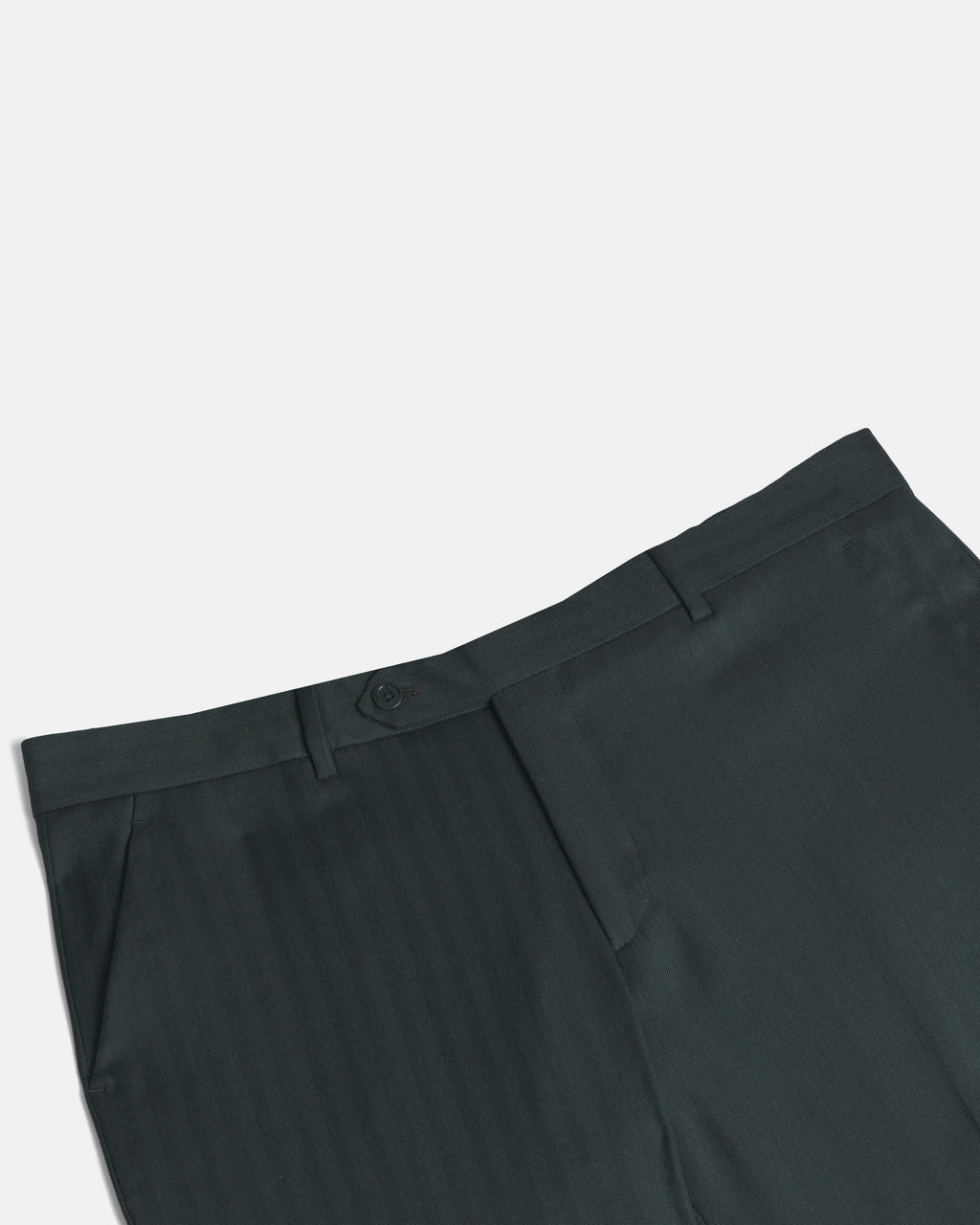 Close-up of dark green pinstriped trousers showing the waistband, button closure, belt loops, and front pleat detail against a light gray background. Color: Midnight Pine Herringbone
