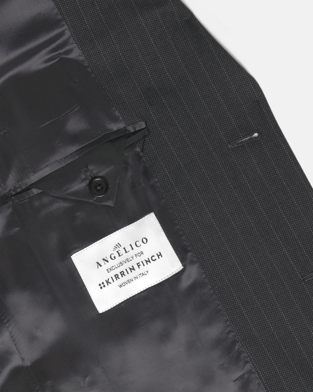 Close-up of a black pinstripe suit jacket showing the inner lining and buttoned pocket flap. Color: Shadow Pinstripe