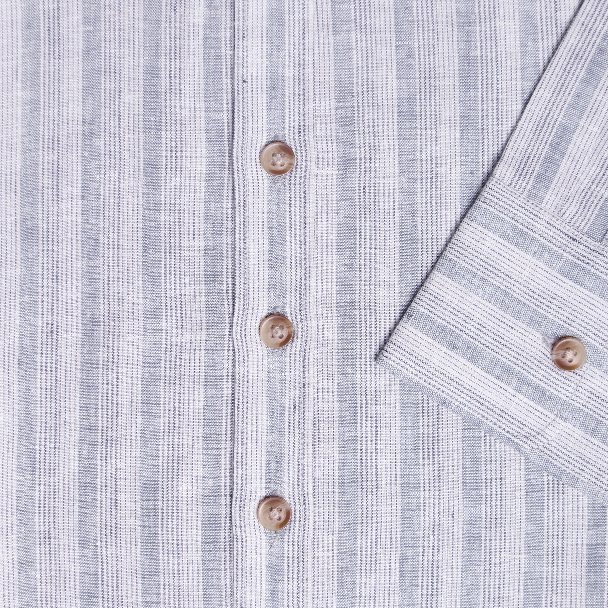 Close-up of a long sleeve shirt showing button and cuff details. Color: Coastal Blue