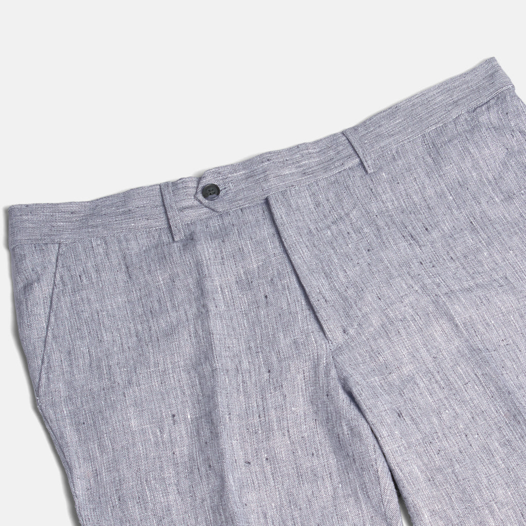Close-up of gray pleated pants on a white background. Color: Graphite