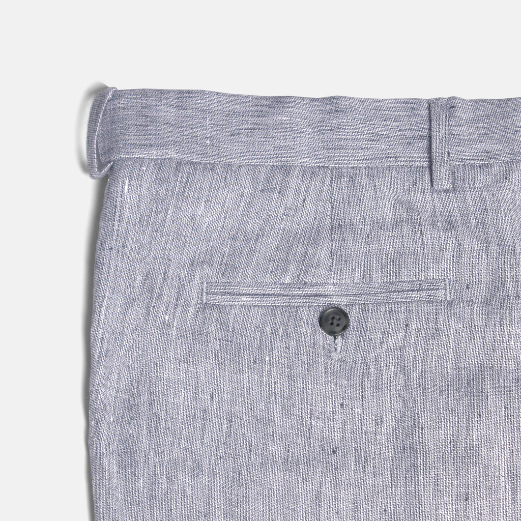 Close-up of gray pants with a button on a light gray background. Color: Graphite
