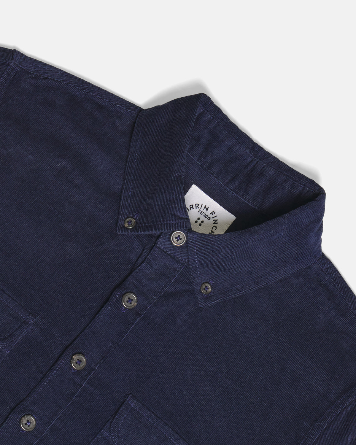 Close-up of a dark navy blue button-down shirt with a pointed collar. Color: Maritime Blue
