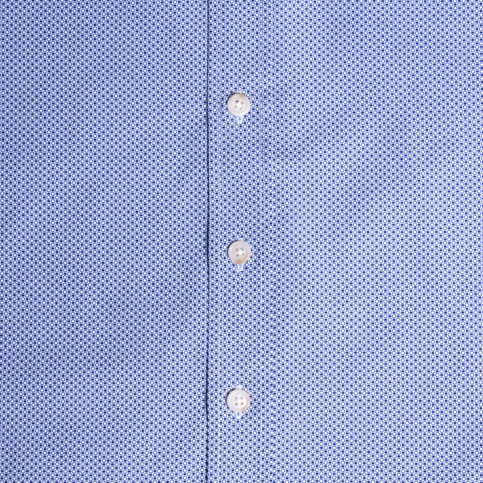 Close-up of womens blue patterned shirt with buttons. Color: Morse Code