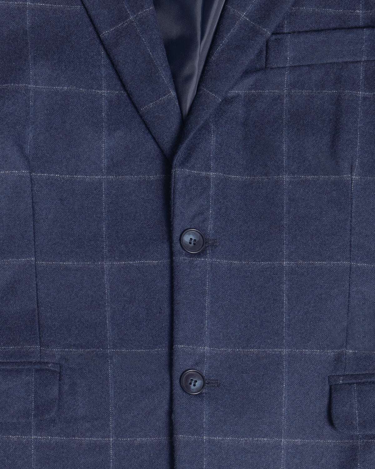 Close-up of a navy blue windowpane plaid blazer fabric, showing the texture, two dark buttons, and a dark satin collar lining. Color: Navy Regatta