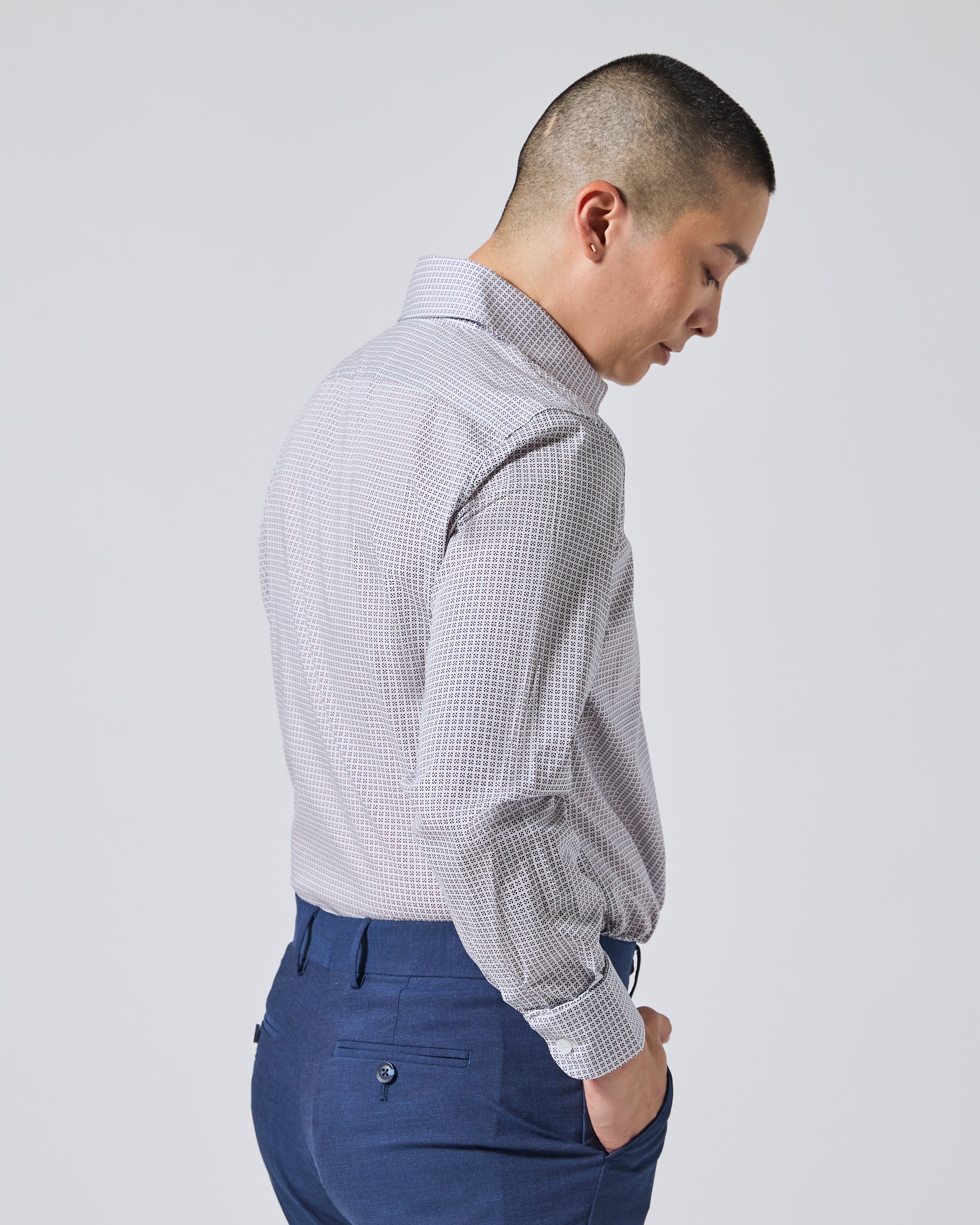 Model shown from the back and side wearing a light gray and white micro- patterned dress shirt. Color: Navy Rosette