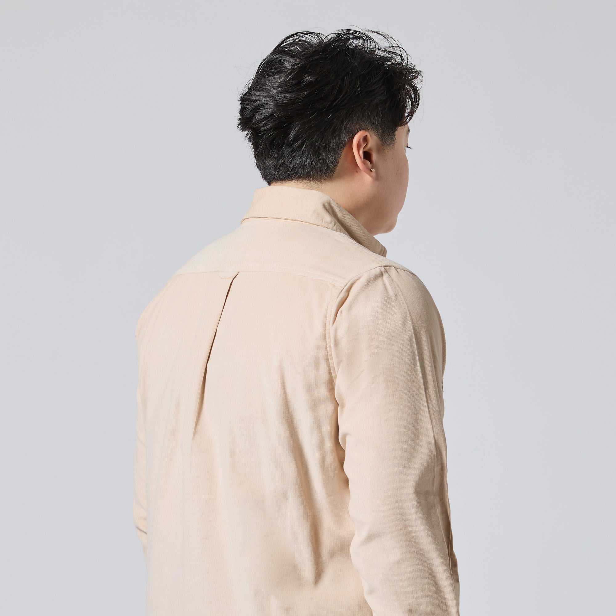 Model shown from the back wearing a light beige shirt, photographed against a solid light gray background. Color: Oatmeal