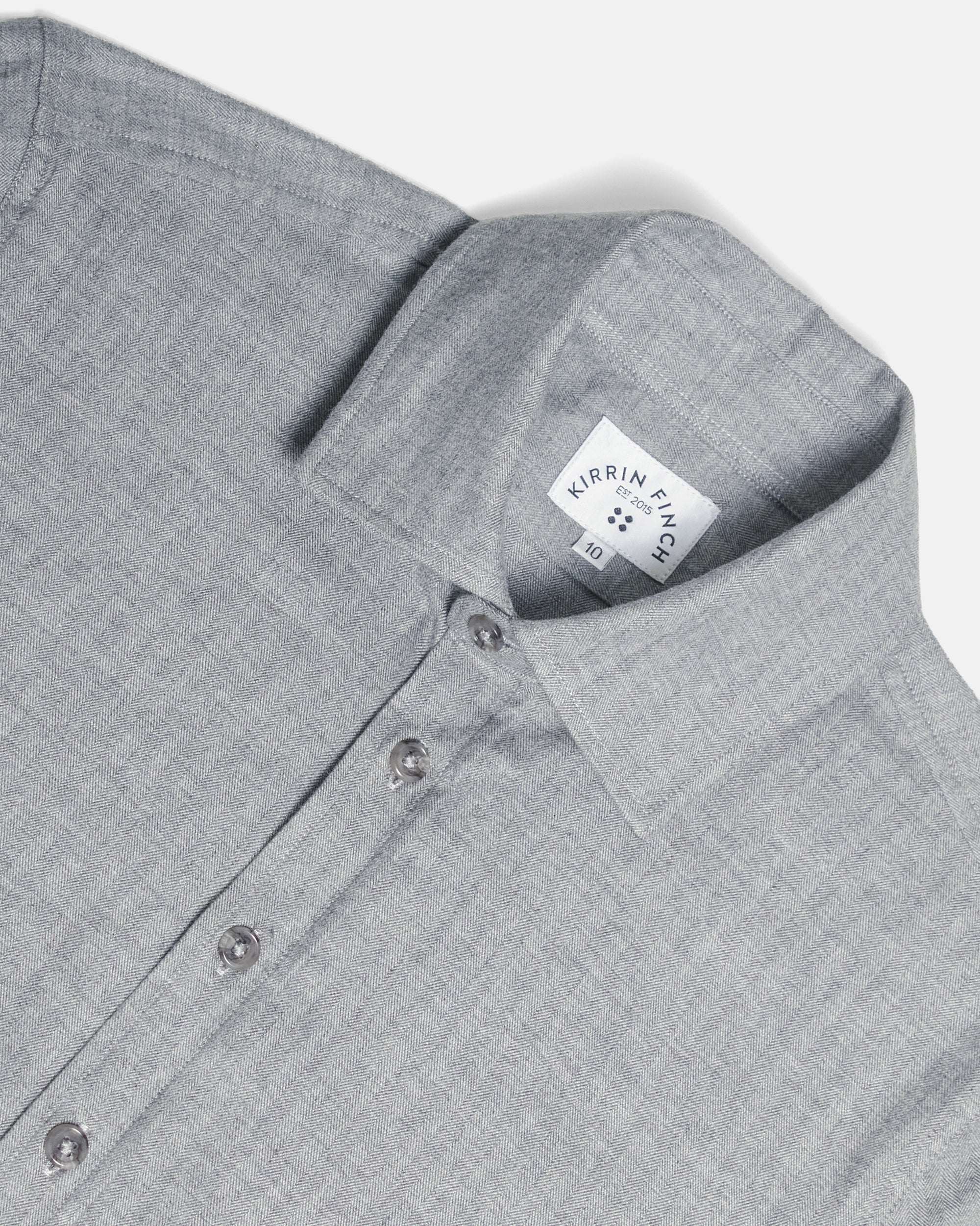 Close-up of a light gray textured button-down shirt collar showing the fabric weave and button details. Color: Pewter Herringbone