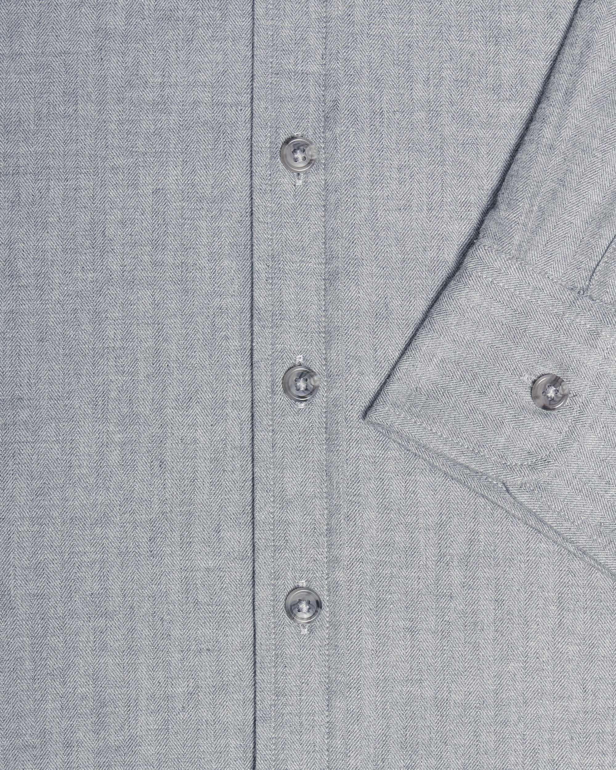 Close-up of a light gray textured button-down shirt showing the button placket and a folded cuff with a button. Color: Pewter Herringbone