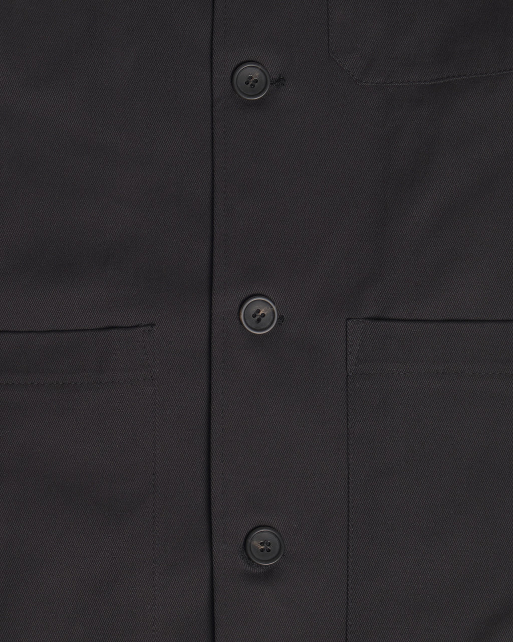Close-up of the Raven Quilted Jacket showing the front button closure, chest pockets, and fabric texture.