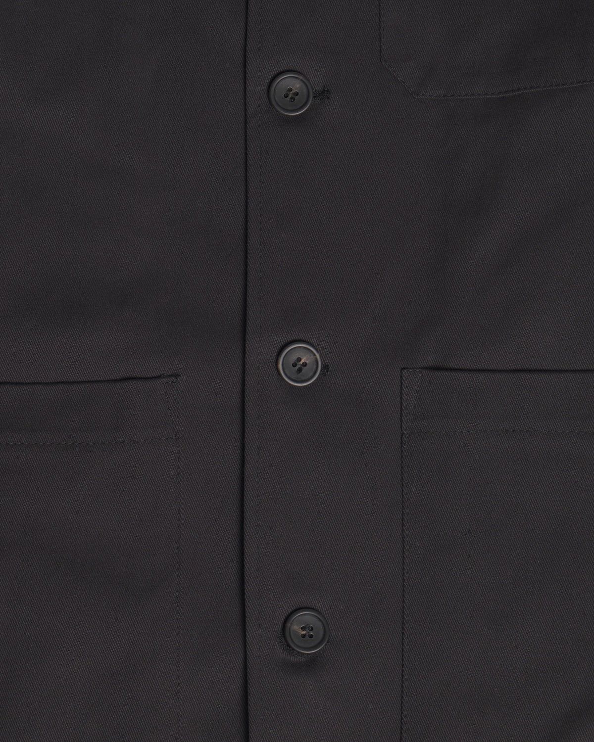 Close-up of the Raven Quilted Jacket showing the front button closure, chest pockets, and fabric texture.