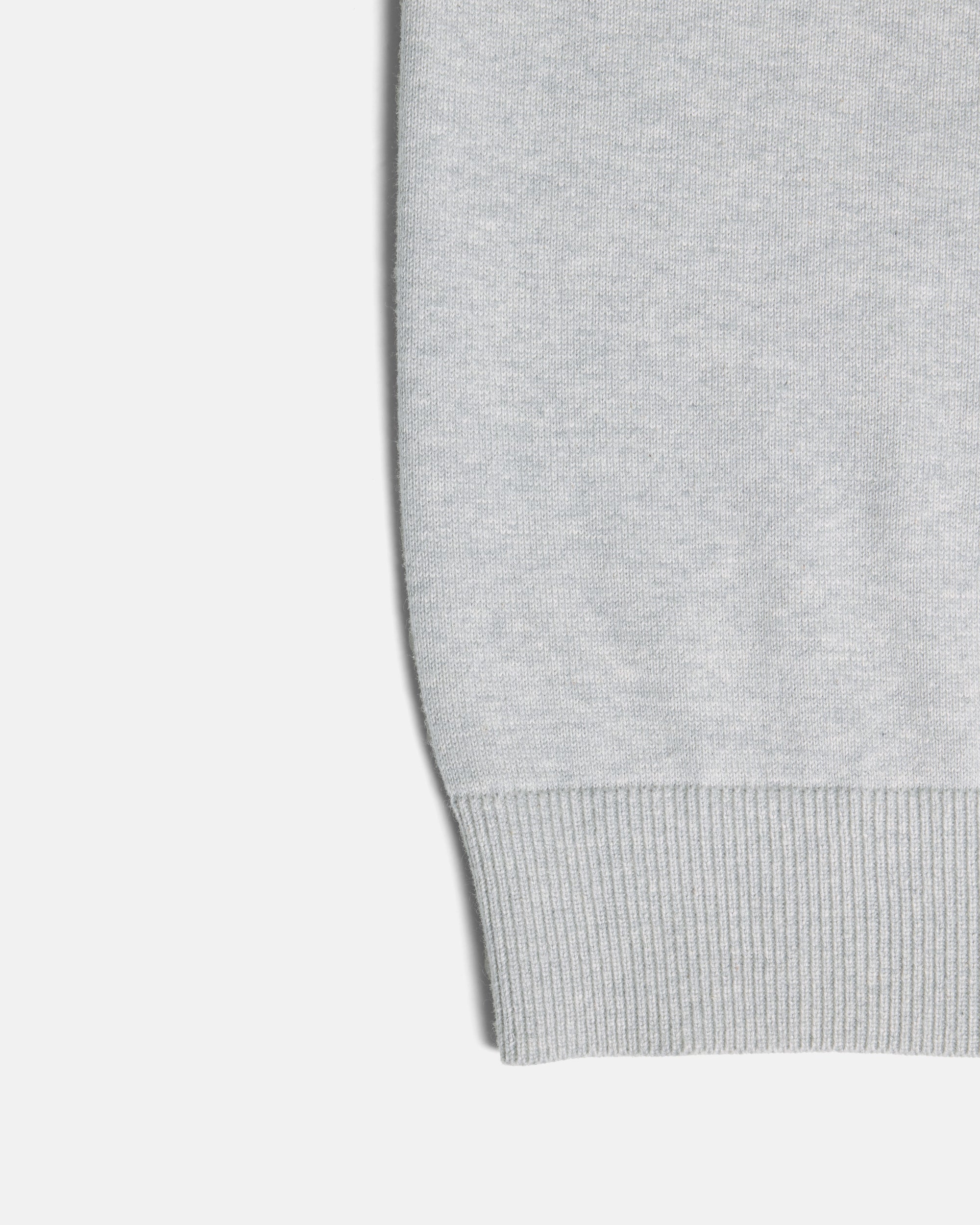 Close-up of a light gray ribbed knit cuff on a plain light background. Color: Heather Grey