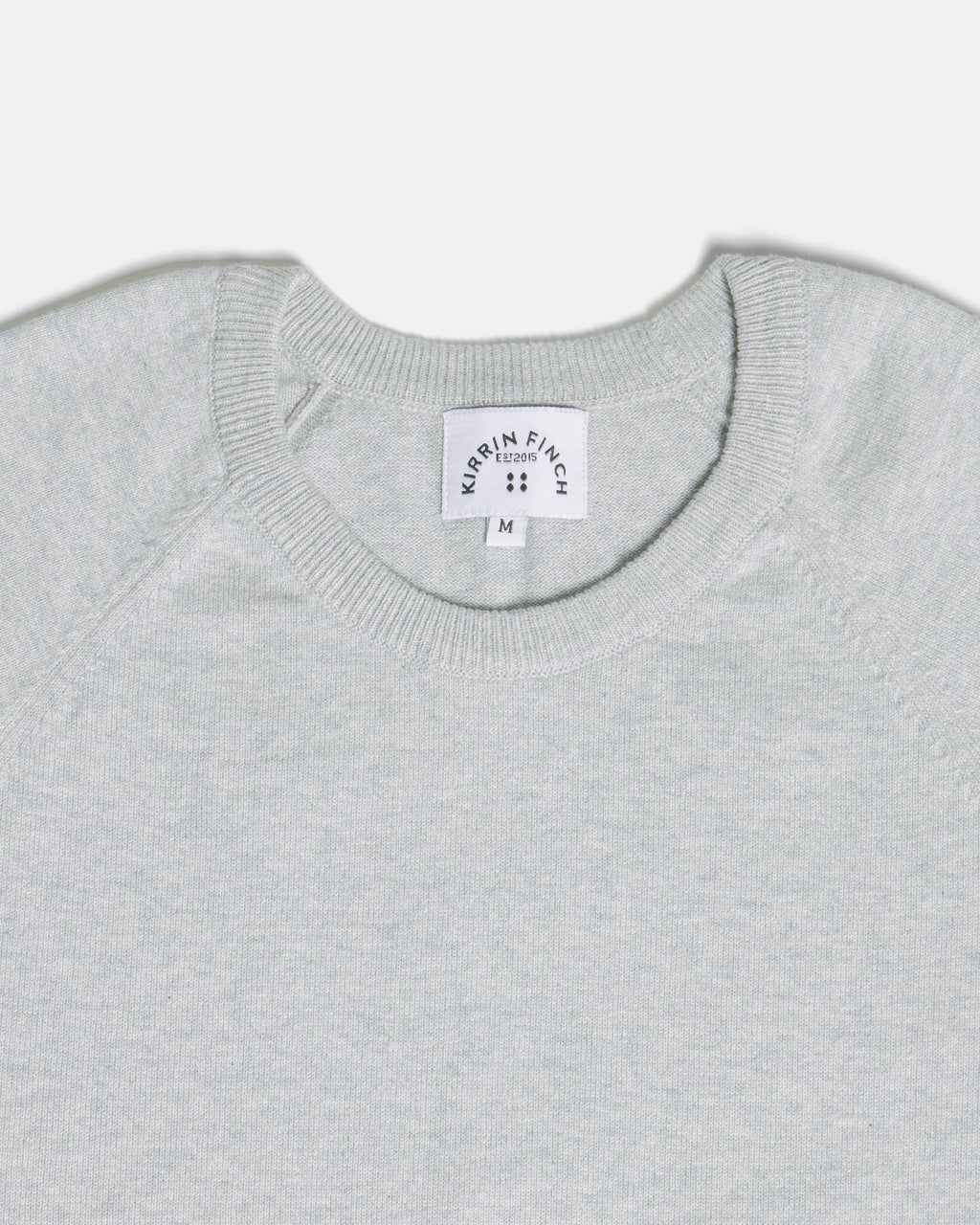 Close-up of a light gray heather crewneck sweater. Color: Heather Grey