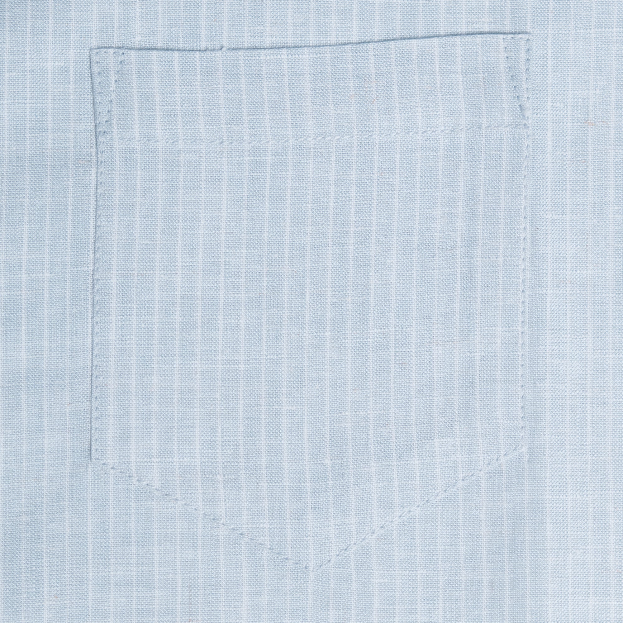 Close-up of light blue fabric with a pocket detail. Color: Curacao
