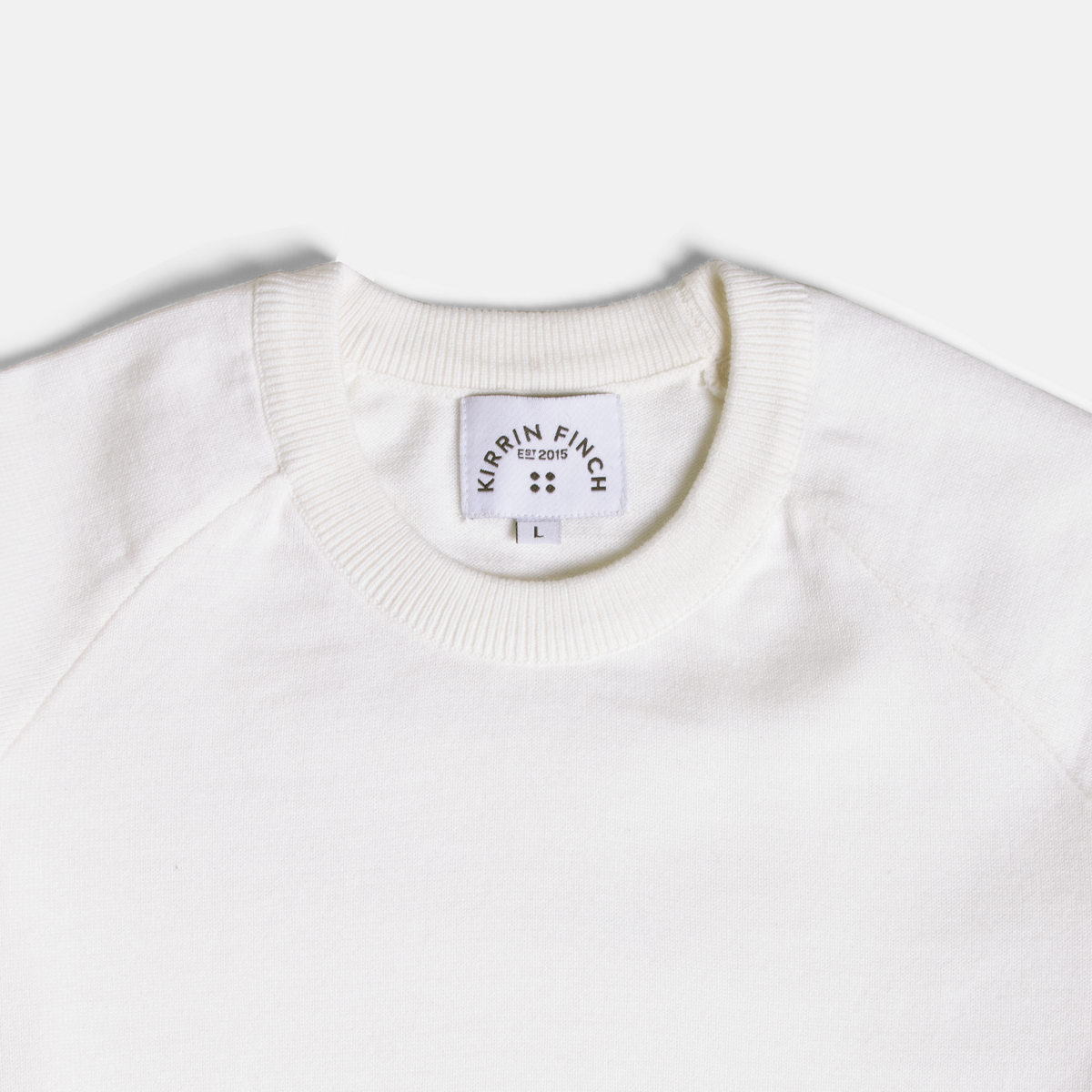 White crewneck shirt on a light gray background. Color: Ivory