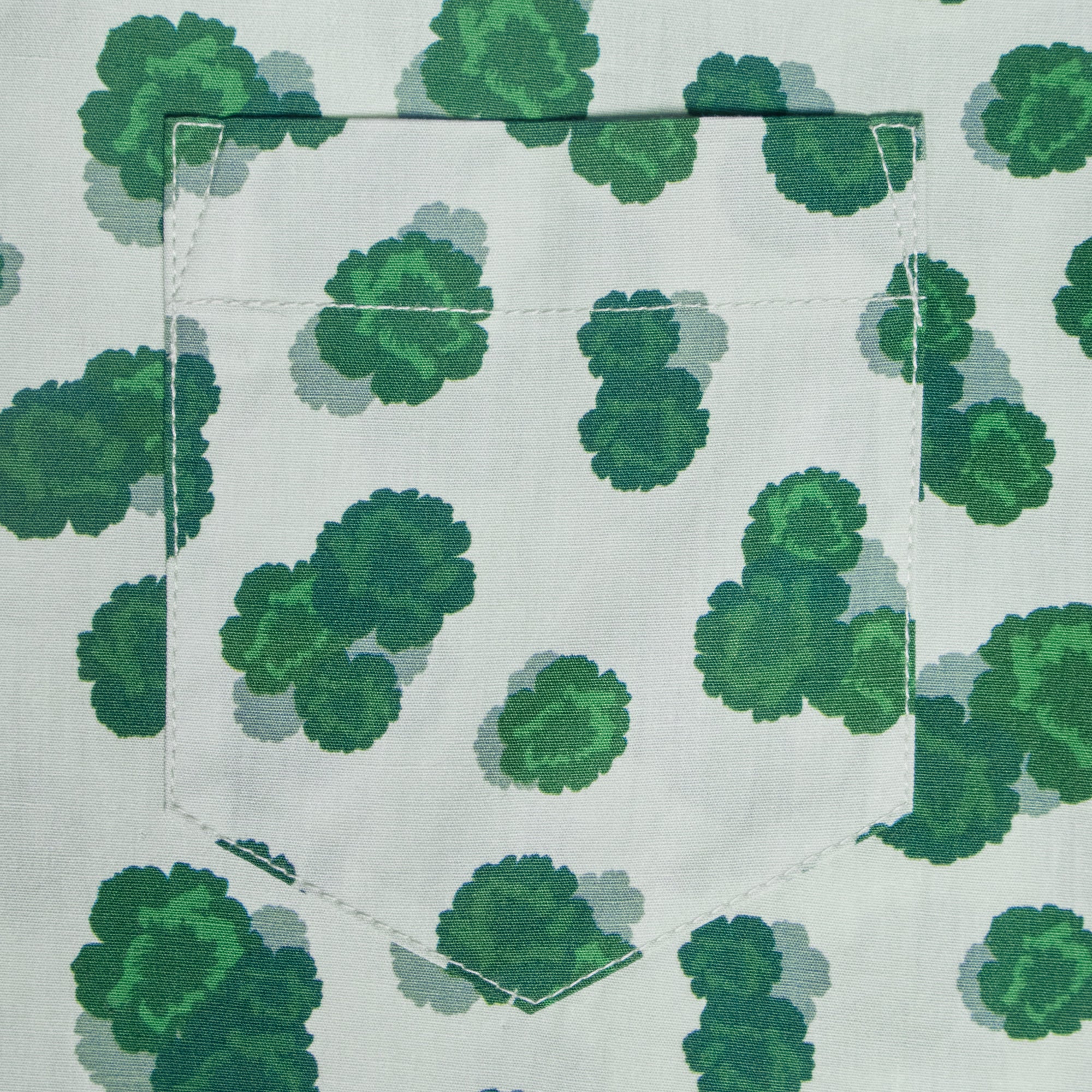 Green leaf pattern on a white background with a pocket. Color: Green Carnation