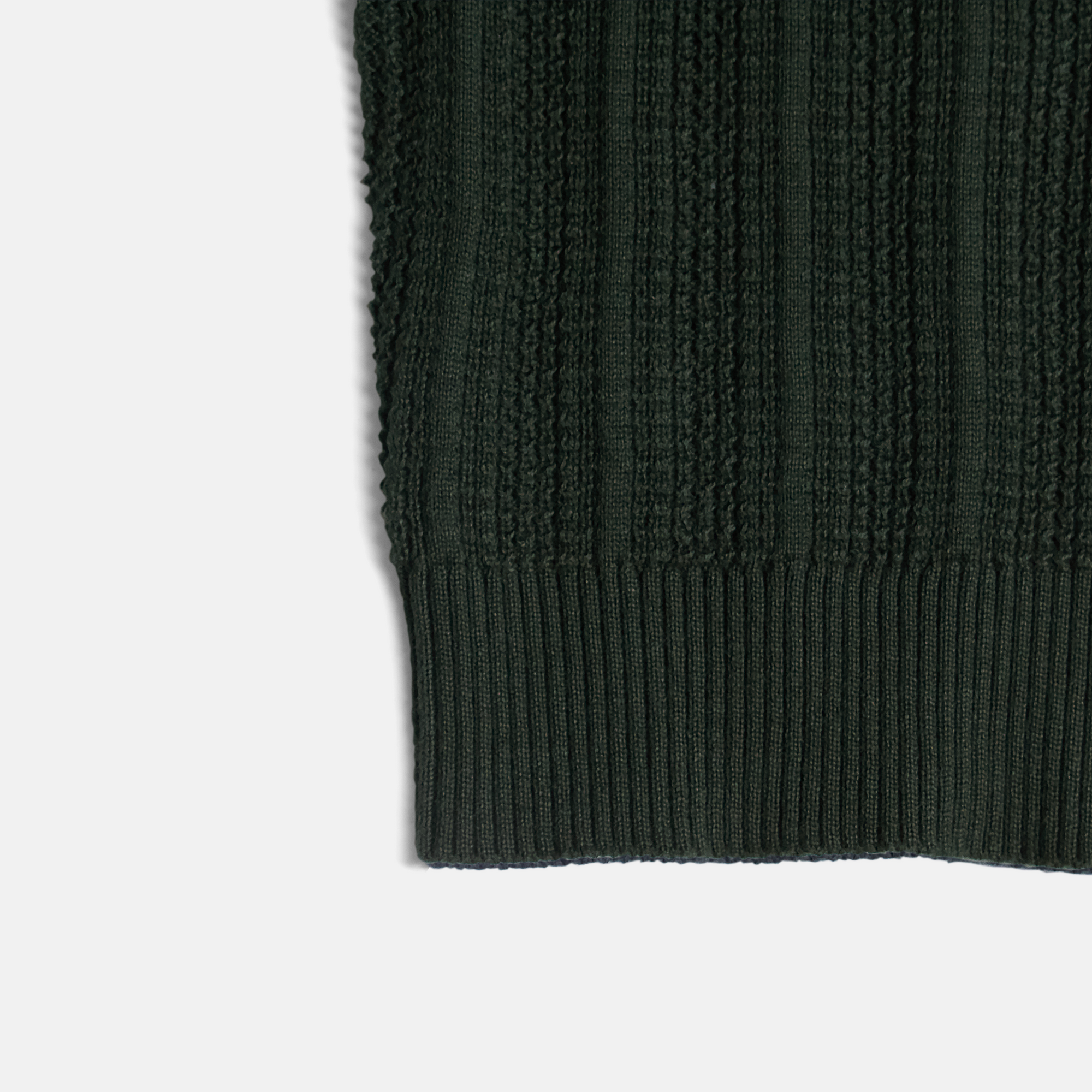 Ribbed cuff of dark green cardigan made by Kirrin Finch.  Color: Evergreen