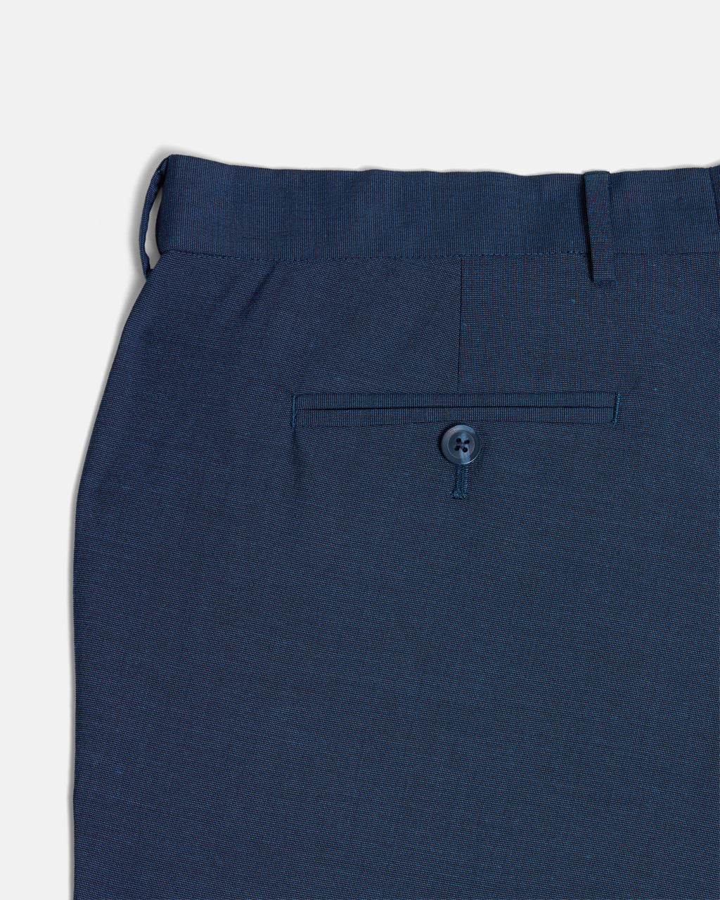 Back pocket of blue Scout dress pants. Color: Atlantic Blue
