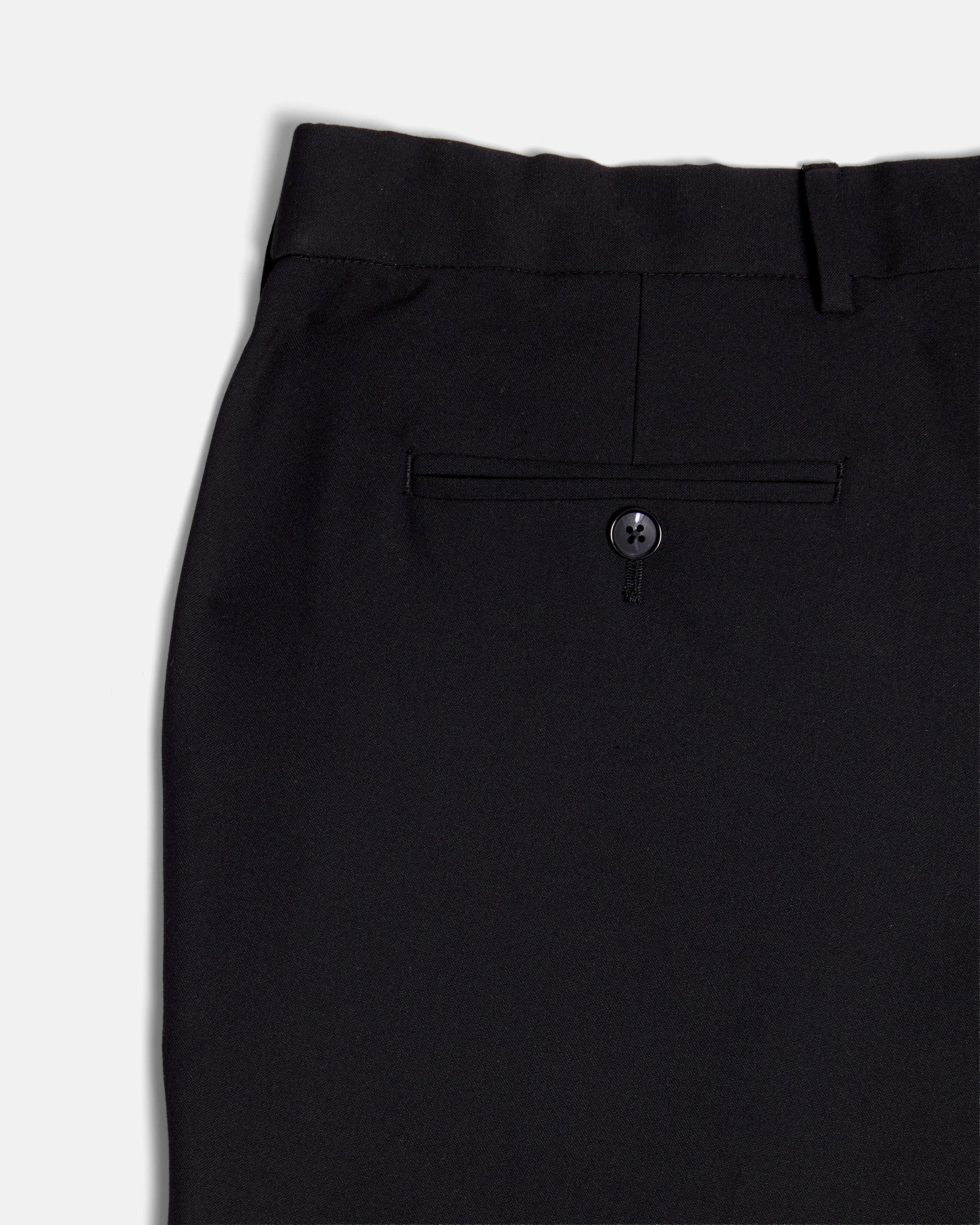 Close-up of black pants with an elastic waistband on a white background. Color: Obsidian