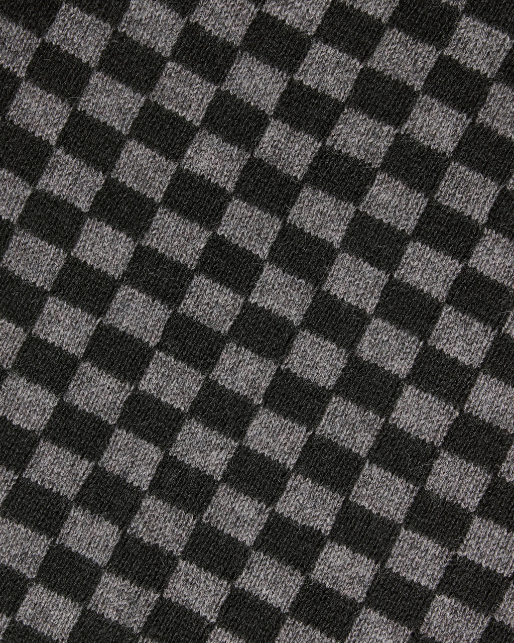 A close-up of a black and gray checkerboard knit fabric texture. Color: Shadow Checker