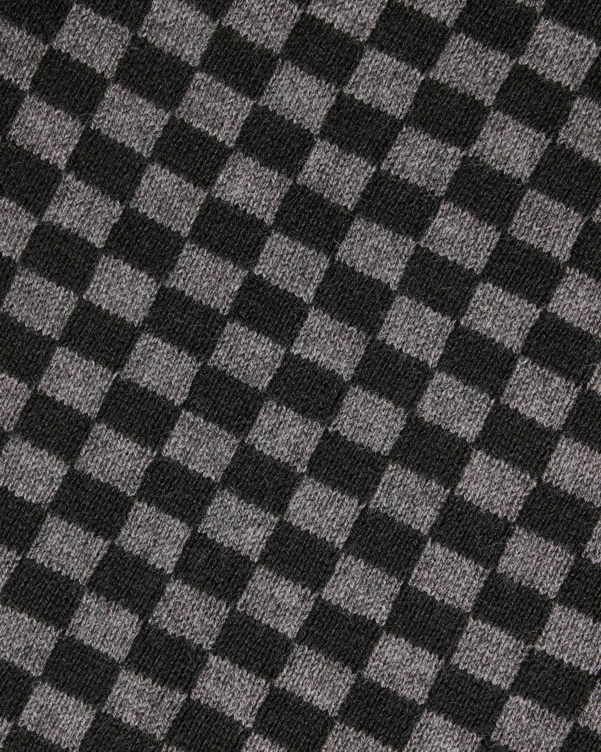A close-up of a black and gray checkerboard knit fabric texture. Color: Shadow Checker