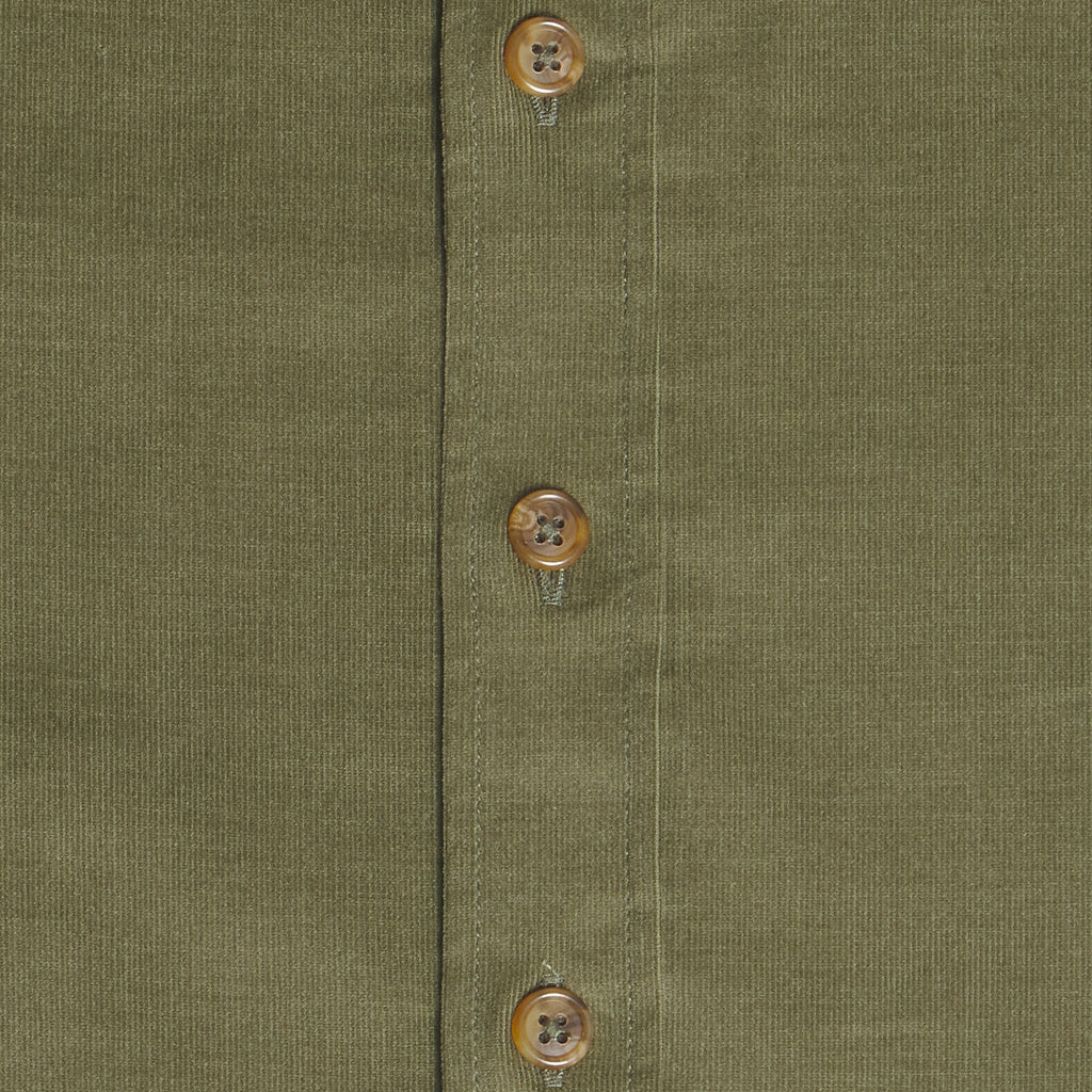 Close-up of an olive green textured fabric garment with a vertical button placket showing three brown buttons. Color: Turtle Corduroy