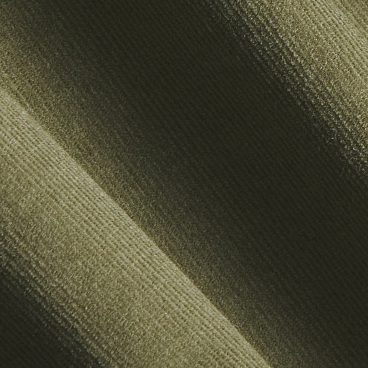 A close-up of ribbed fabric texture in a dark olive green color, showing the material's fine vertical ribbing and soft diagonal folds. Color: Turtle Corduroy