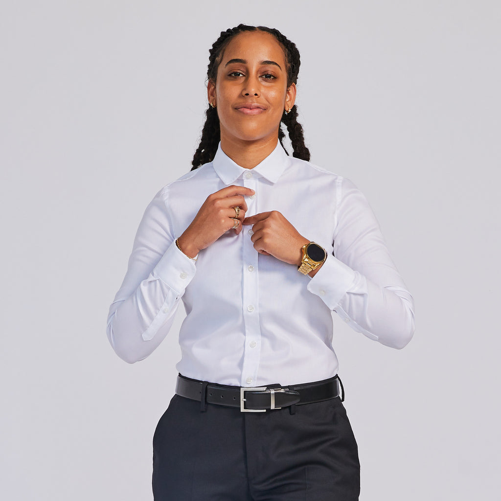 Model buttoning  Addams White Easy Care Dress Shirt and Black dress pants by Kirrin Finch Color: White 