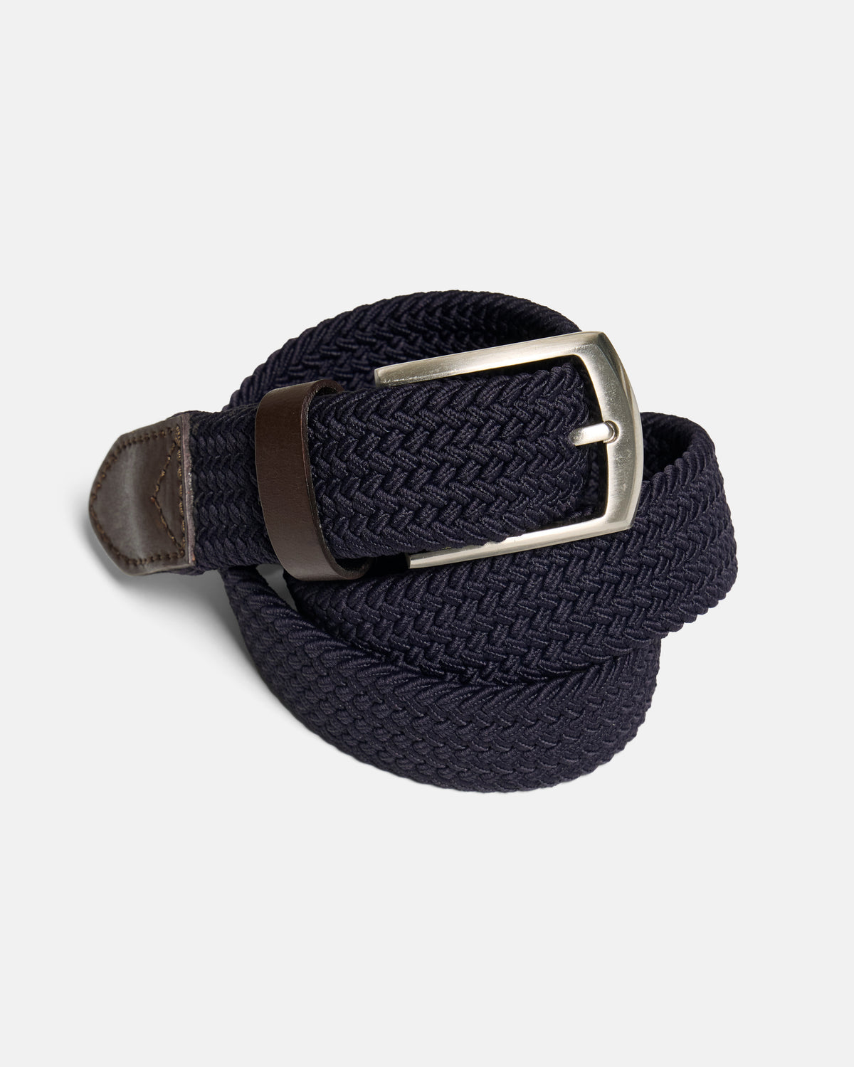 A navy blue braided elastic belt with a silver-tone metal buckle and a brown leather tip, coiled on a light gray background. Color: Navy