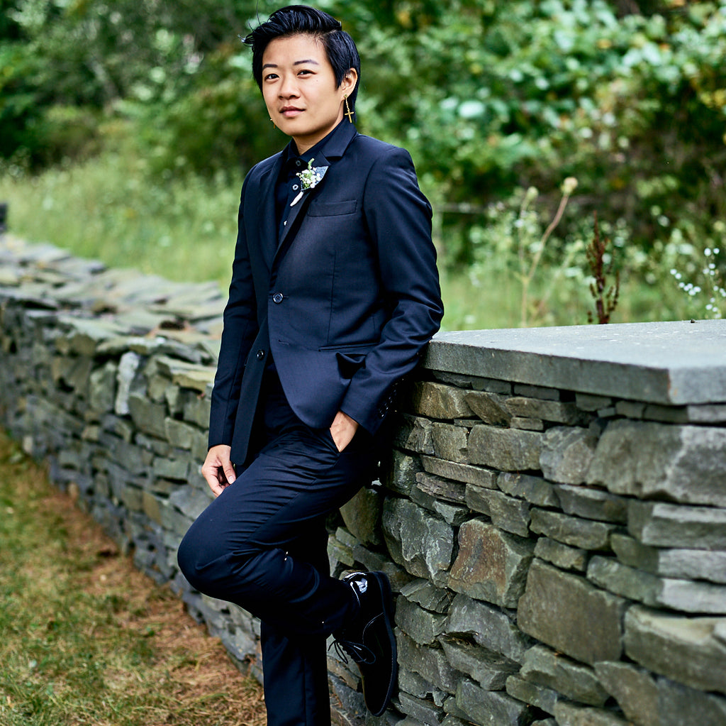 Masc person in Black Georgie Suit by Kirrin Finch