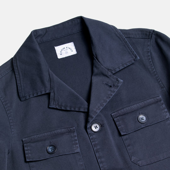 Navy utility jacket close-up on color and coordinating navy faux horn buttons