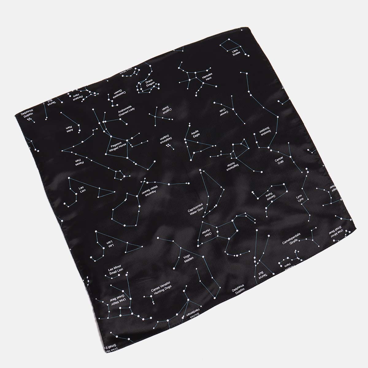 Black constellation pocket square by Kirrin Finch. It is 13 by 13 on a neutral background