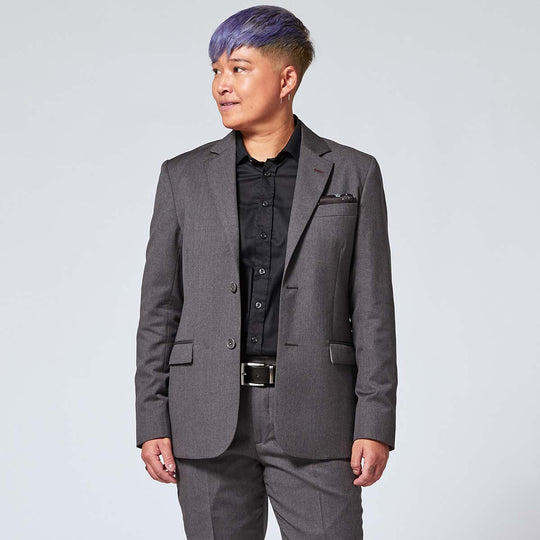 non-binary model wearing the Georgie Charcoal Suit styled with the black constellation pocket square