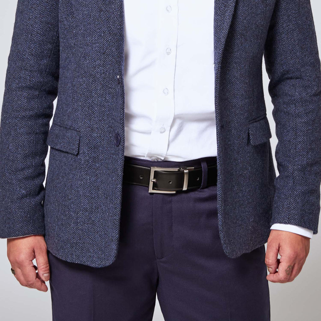 Black leather belt with zinc belt buckle on model wearing Georgie navy blue pants and navy blue tweed blazer.