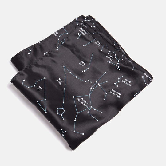Viscose Pocket square with a Black Constellation pattern. The pocket square has been folded twice into a smaller square on a neutral background