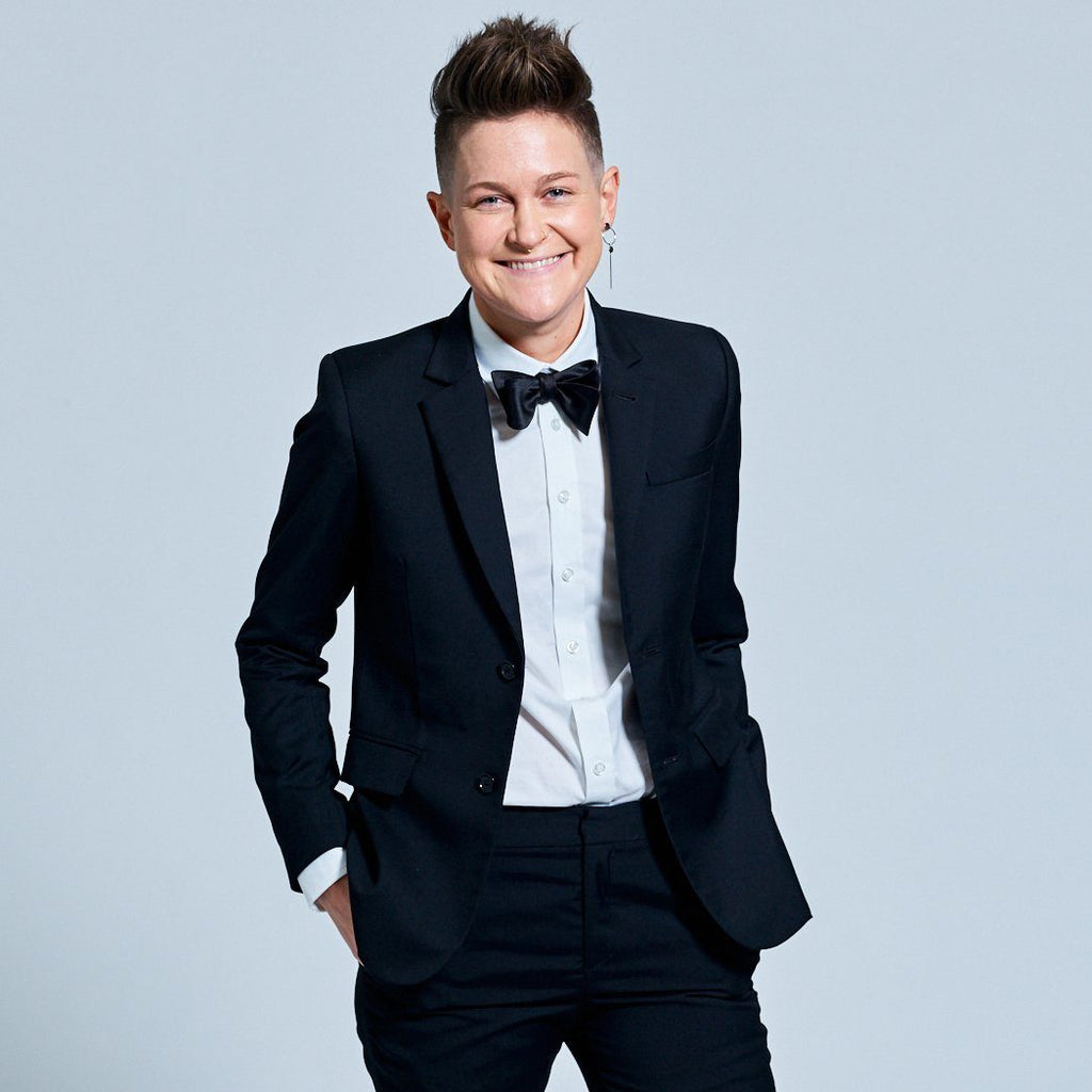 Androgynous model in Georgie formal black suit and classic white dress shirt.