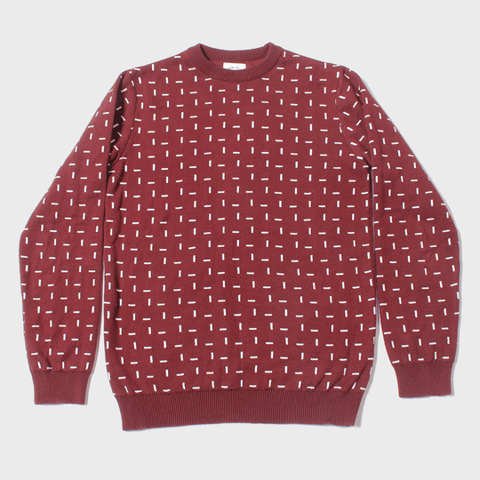 Kirrin Finch's burgundy sweater with white dashes on neutral background