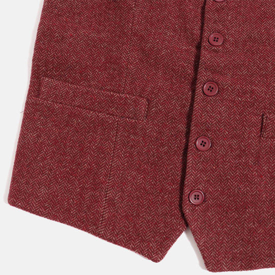 Detail shot of left vest pocket and burgundy buttons on burgundy herringbone tweed vest by Kirrin Finch