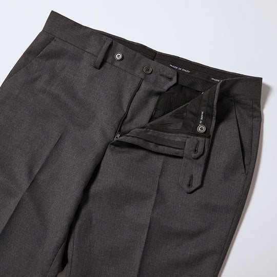 The Georgie Charcoal Dress Pants flat showing interior waistband. Made in intake is stitched into this wasitband several times. Waist has double button enclosures also in charcoal