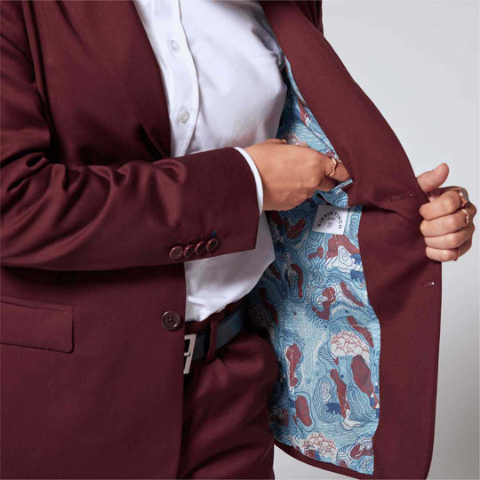 Masc Model opening blazer to reveal interior deep pocket and Kirrin Finch logo tag