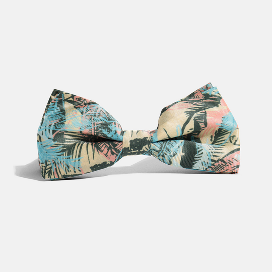 Gold leaf print bow tie on neutral background, tied to perfection.