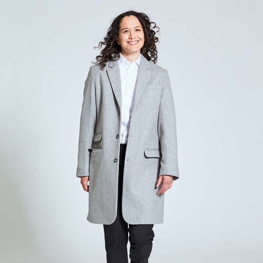 Model wearing wool Gray Overcoat by Kirrin Finch over white dress shirt and black pants