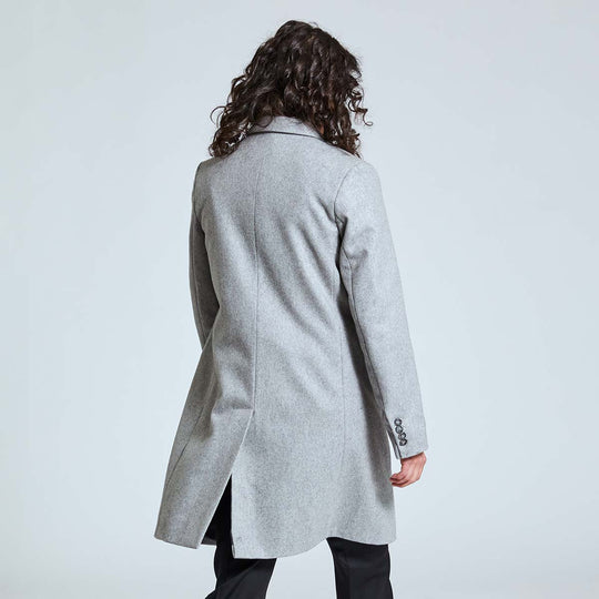 Model showing off the back of Kirrin Finch Gray Wool Overcoat and accent sleeve buttons