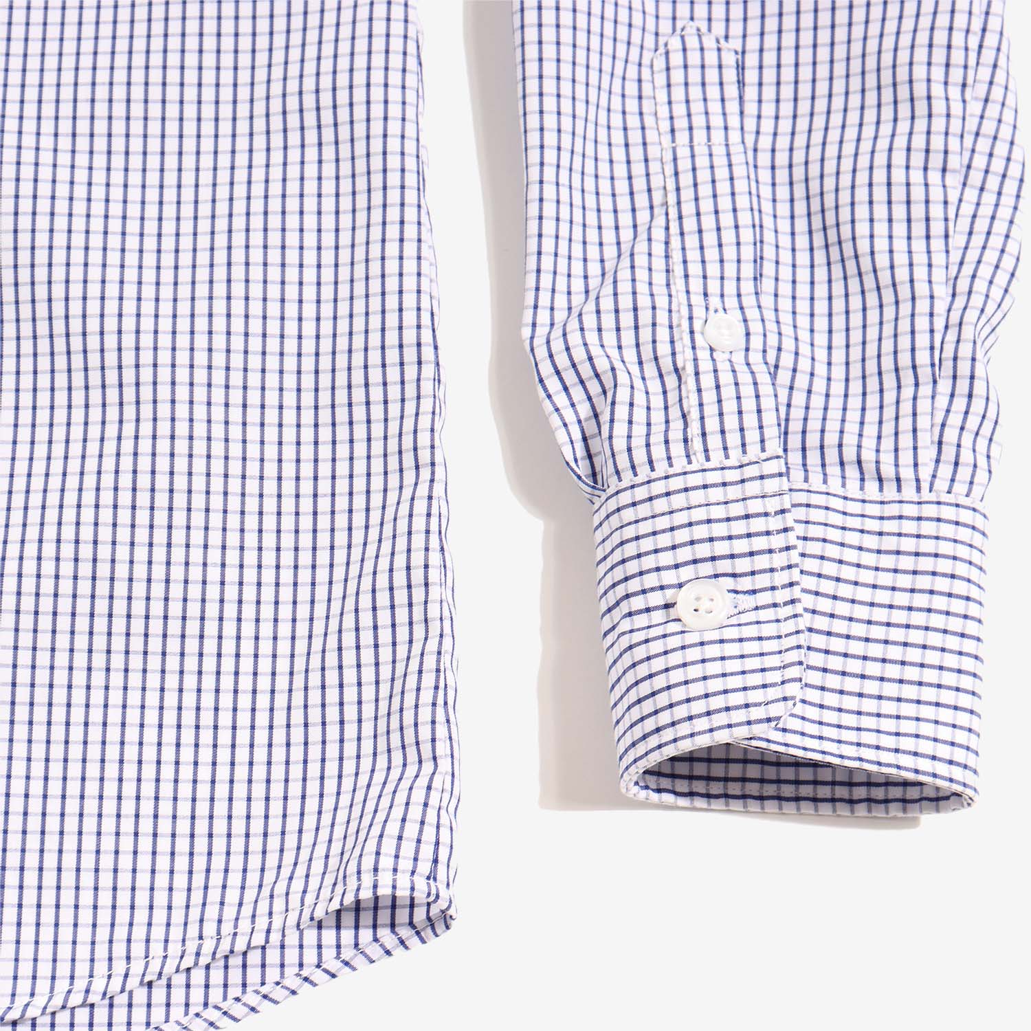 Grid shirt Navy and white sleeve detail with white button on cuff. Color: Navy Grid