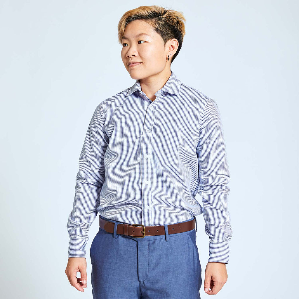 Androgynous model wearing navy and white grid dress shirt by Kirrin Finch. Made in Italy.