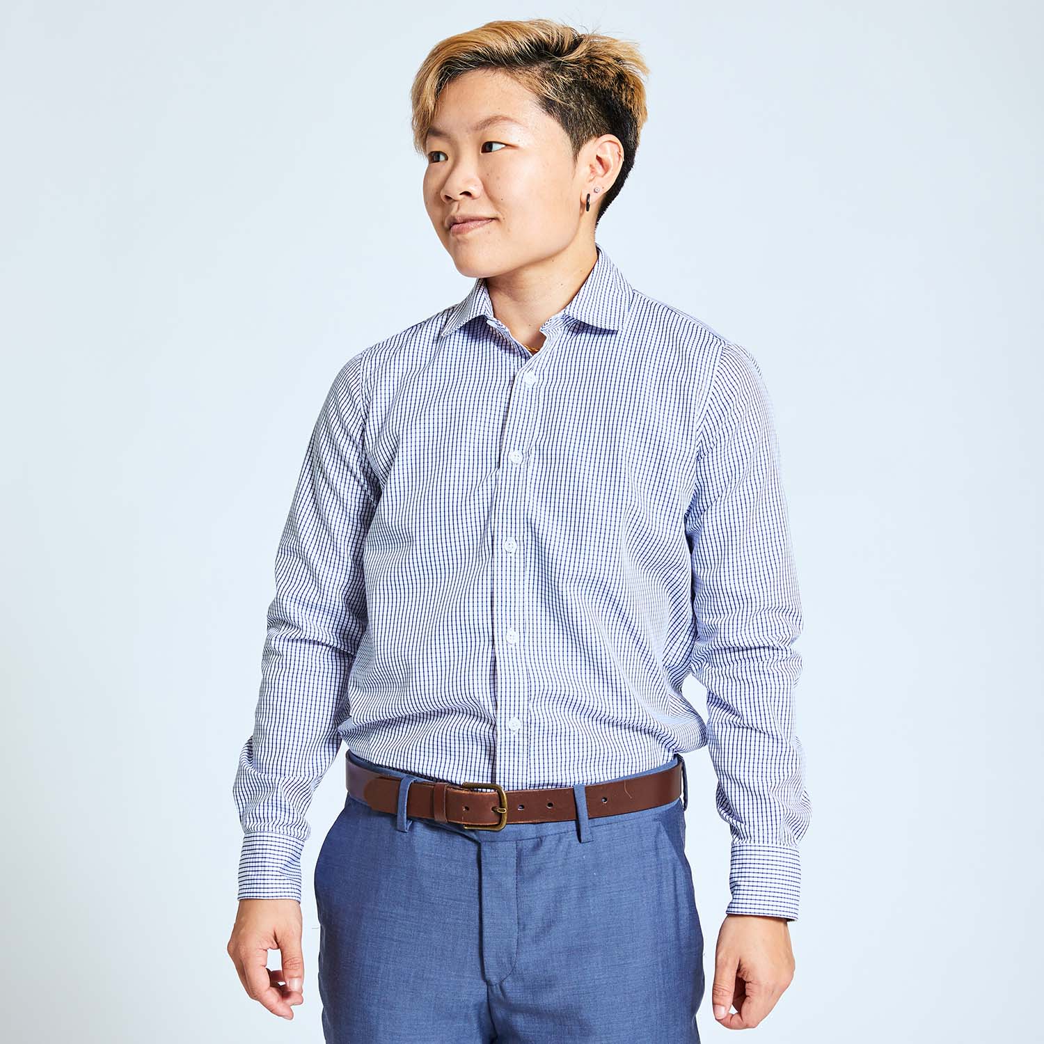 Androgynous model wearing navy and white grid dress shirt by Kirrin Finch. Made in Italy.